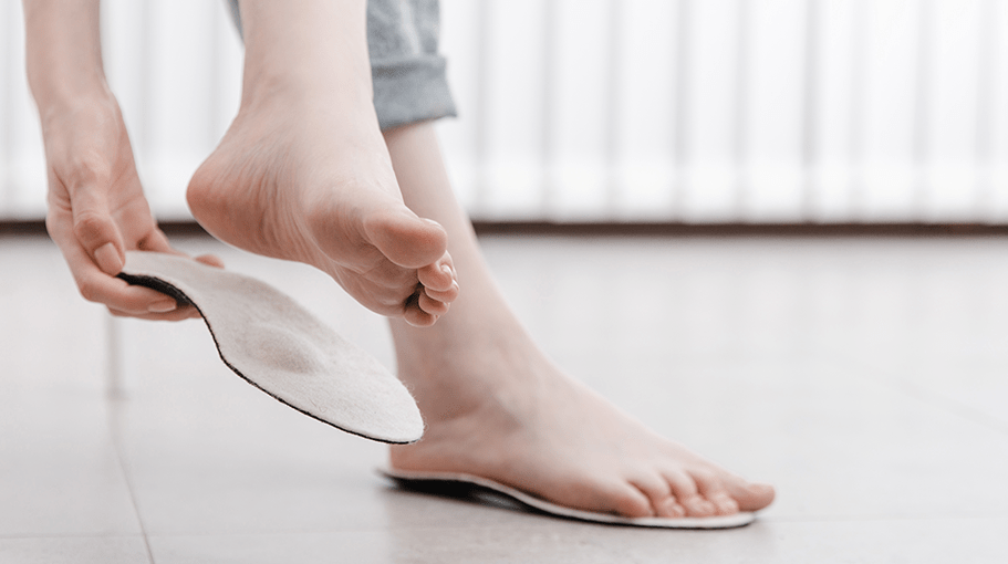 woman fitting an insole for heel pain